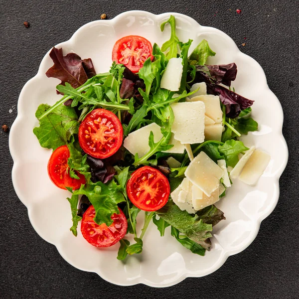 Parmesan peynirli sebze salatası domates, roka, yeşil yaprak marul sağlıklı yemek ana yemek aperatifi taze lezzetli gurme yemek arkaplanı masa rustik yemek üst görünüm uzay keto ve paleo diyet vejetaryen gıda