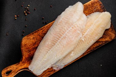 Donmuş balık fileto beyaz balık pangasius deniz ürünleri lezzetli leziz lezzetli gurme lezzetli diyet arka planı masadaki kırsal yemek üst görüşü uzay keto ve paleo diyet