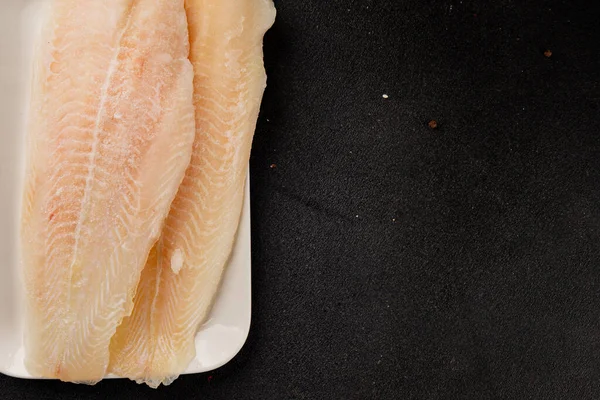 Donmuş balık fileto beyaz balık pangasius deniz ürünleri lezzetli leziz lezzetli gurme lezzetli diyet arka planı masadaki kırsal yemek üst görüşü uzay keto ve paleo diyet