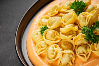 Kase içinde Ravioli makarna sosu ana yemek hazır aperatif lezzetli leziz gurme yemek arkaplanı masa rustik yemek üst görünümü fotokopi alanı