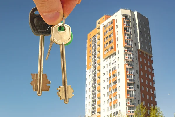 Les clés de l'appartement en main sur le fond des maisons — Photo