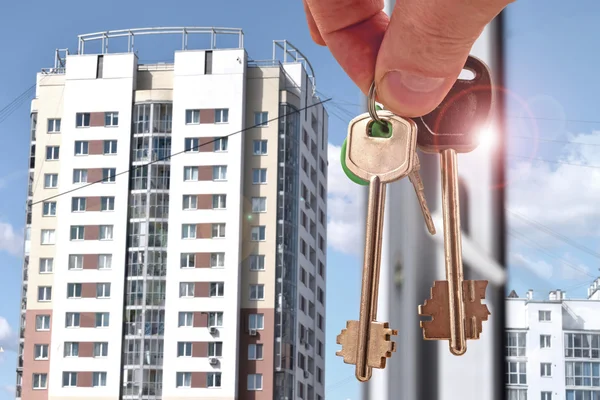 The keys to the apartment in the background of a house . Royalty Free Stock Photos