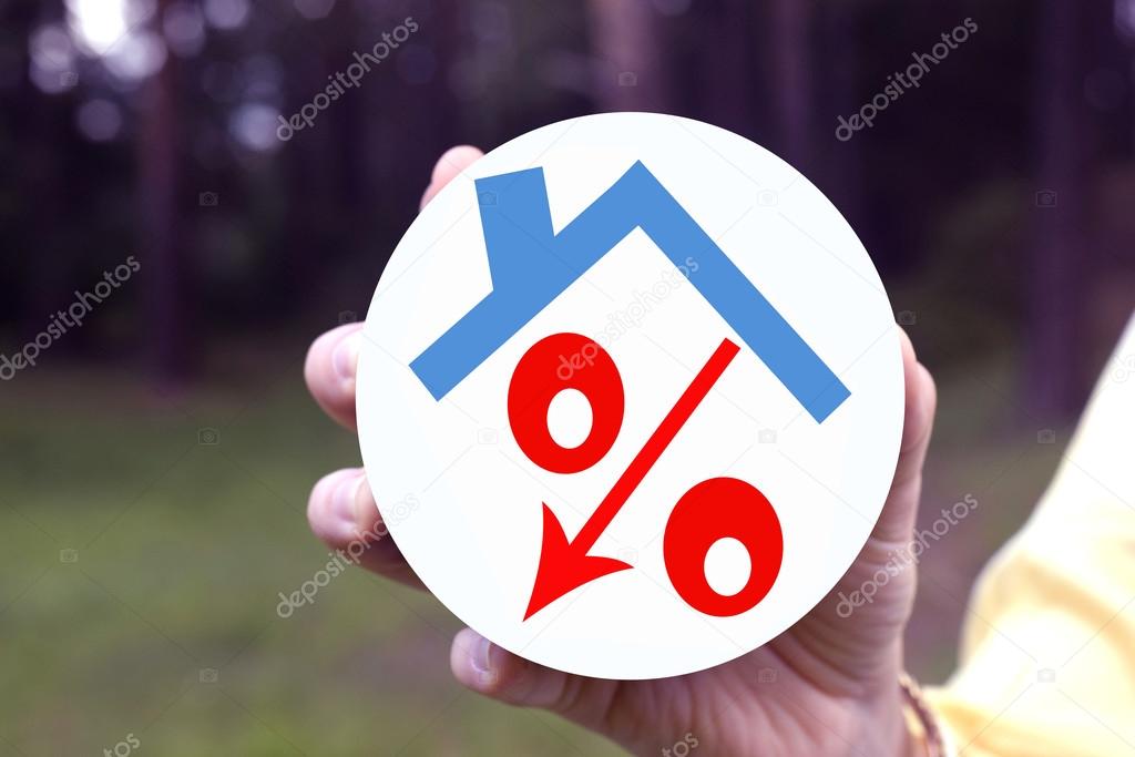 Red percent under the roof in a woman's hand