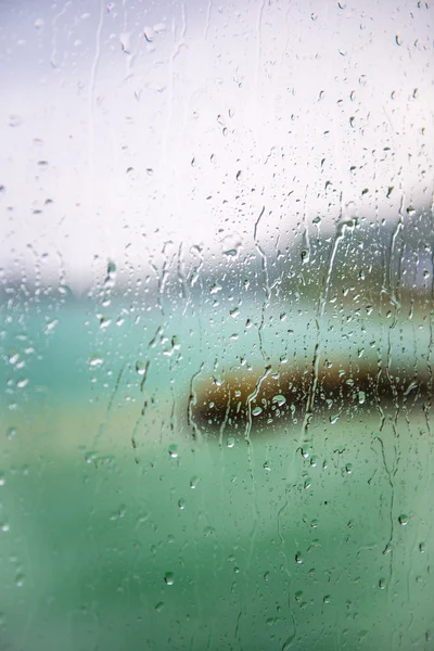 View of the lake through a window with wet glass — Stock Photo, Image