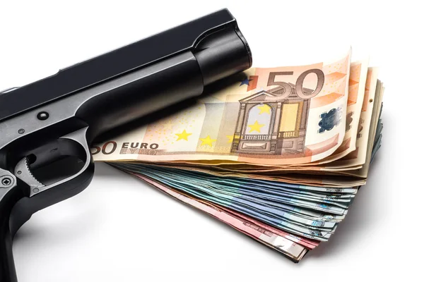 Banknotenbündel mit Waffe lizenzfreie Stockfotos