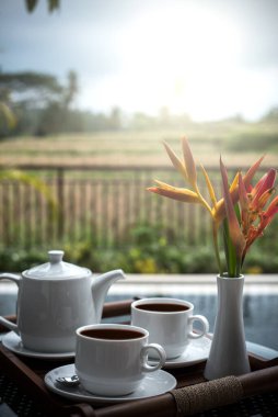 Sehpanın üzerinde pirinç tarlası arkaplanlı kahve sabahı..