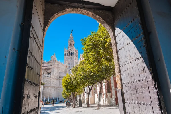 Seville, Spain; July 1 2020. Seville Cathedral Giralda tower from Alcazar arch door.