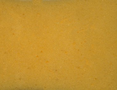 Yellow porous texture. The texture of the sponge. Closeup