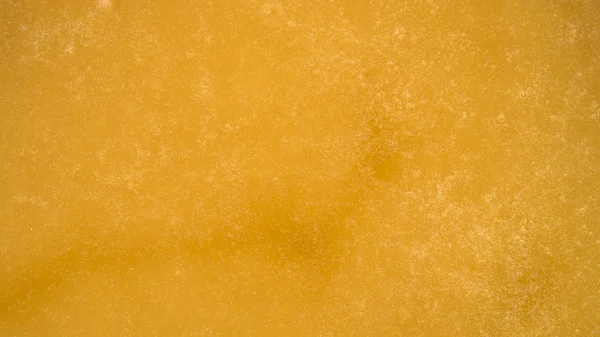 Texture dorata frizzante di miele. Primo piano — Foto Stock