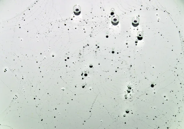 White transparent fluid texture with patterns and bubbles. White clear water with bubbles. Closeup