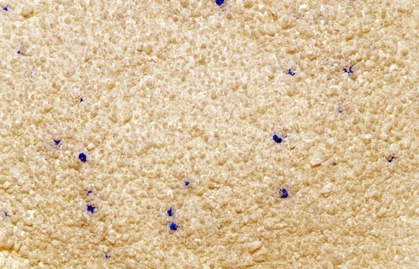 Texture marrone giallo con una punta blu. La consistenza dei granuli. Primo piano — Foto Stock