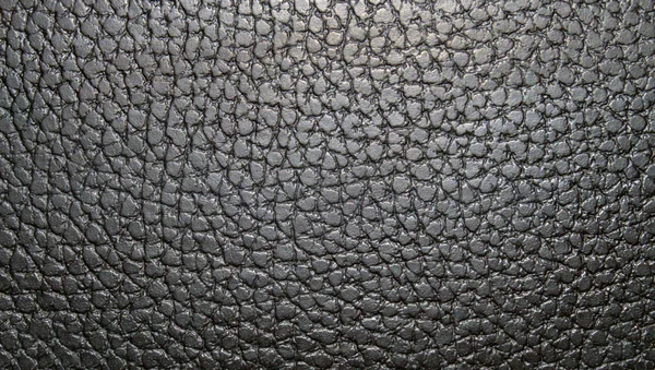 Texture noire pâle en cuir, avec un motif rond. Texture cuir. Gros plan — Photo