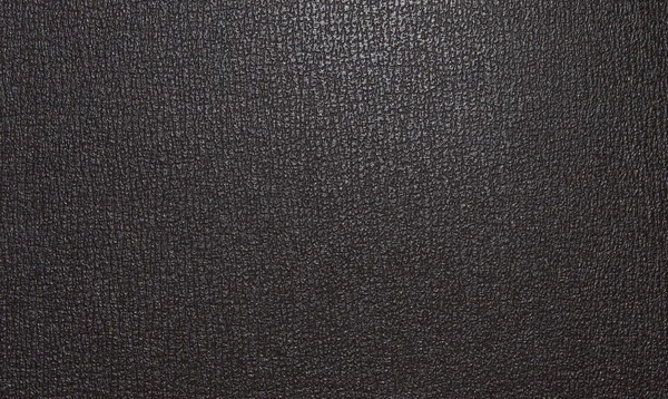 Light brown leather texture, with a pattern of figures of irregular shape. Leather texture. Closeup