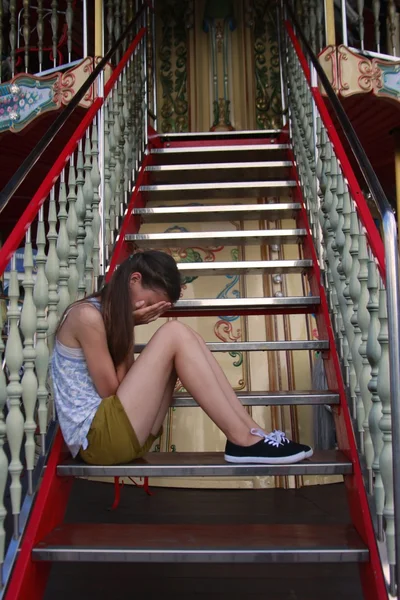 sad little girl sitting on stairs