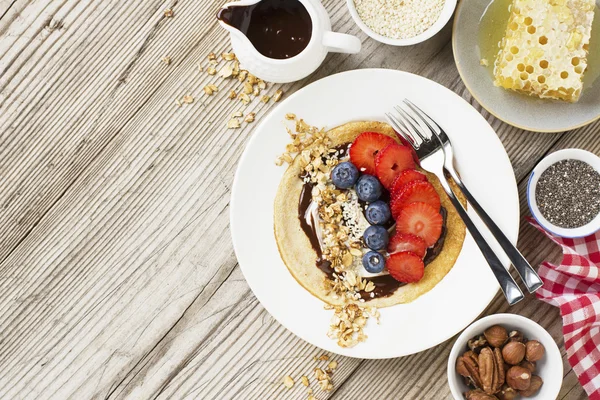 Oatmeal pancakes in a frying pan on wooden table — Stock Photo, Image