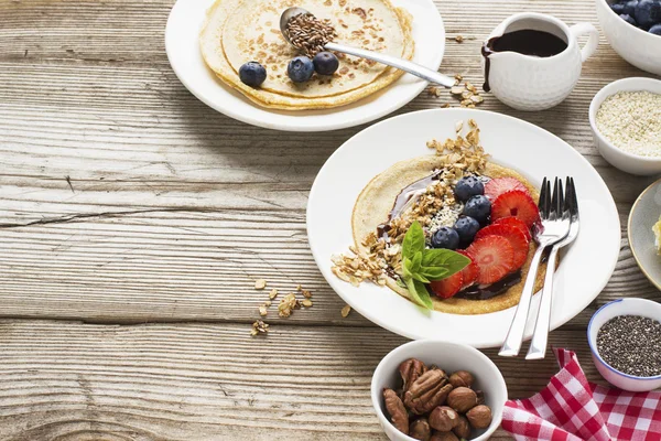 Oatmeal pancakes in a frying pan on wooden table — Stock Photo, Image