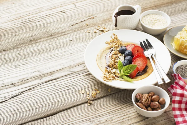 Crêpes à l'avoine dans une poêle sur une table en bois Photo De Stock