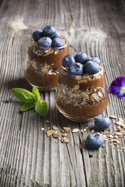 Sağlıklı ev yapımı kahvaltı. Gevrek gevrek ve taze meyveler yaban mersini çikolatalı muz smoothie