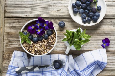 Bir tepesi granola, yaban mersini, beyaz susam ile Çikolatalı muz Smoothies kase