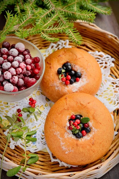 Plate of homemade buns with berries, served on old wooden table — Stock Photo, Image