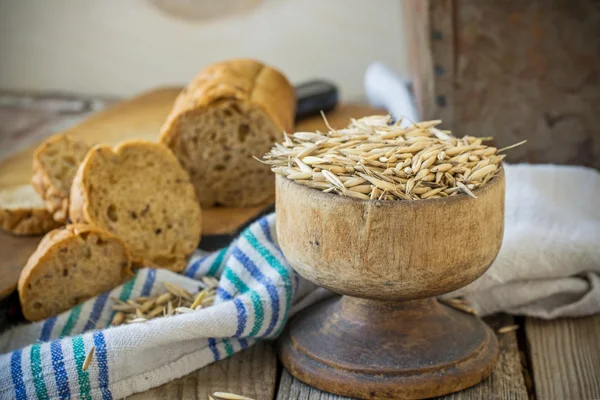 Oat and oat bread on wooden background — ストック写真