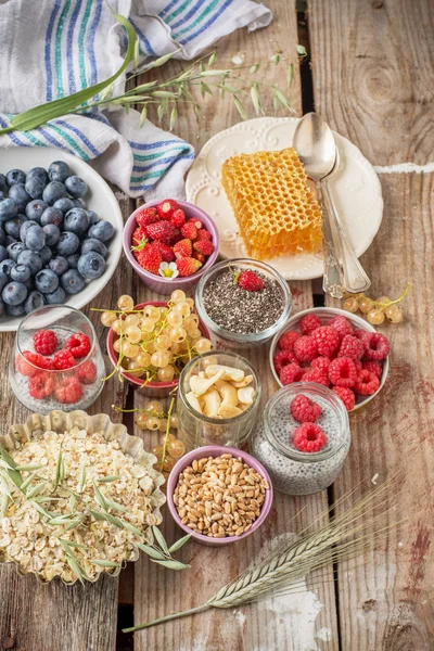 Cereal and various delicious ingredients for breakfast, vertical, top view — Stock Photo, Image