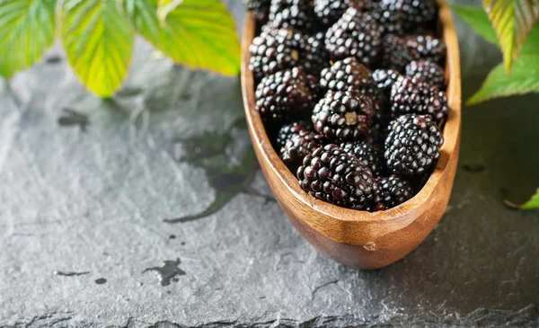 Fresh blackberries in wooden bowl. Top view. — Stock Photo, Image