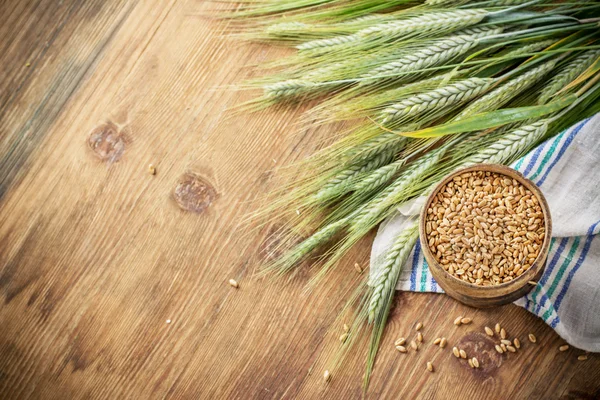 Orecchie di grano sulla tavola di legno — Foto Stock