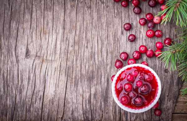 Sauce of wild organic cranberries on a wooden table — Stock Photo, Image