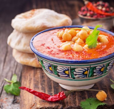 Cream soup puree of roasted tomatoes and peppers served with chickpeas cilantro