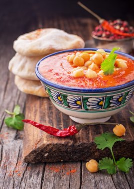Cream soup puree of roasted tomatoes and peppers served with chickpeas cilantro