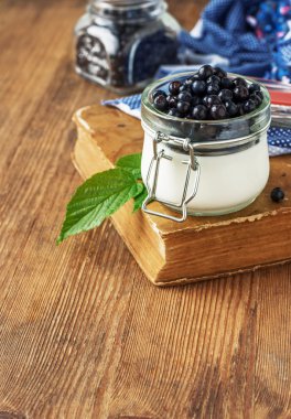 Fresh yogurt for breakfast with blueberries in a glass jar batch