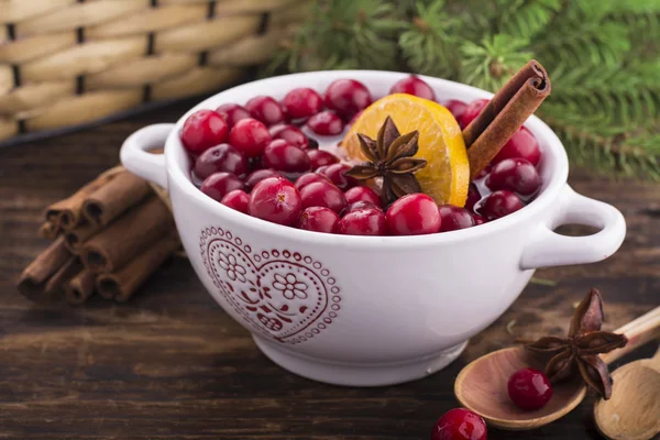 Cranberries with orange, cinnamon and star anise in a white ceramic — Stock Photo, Image