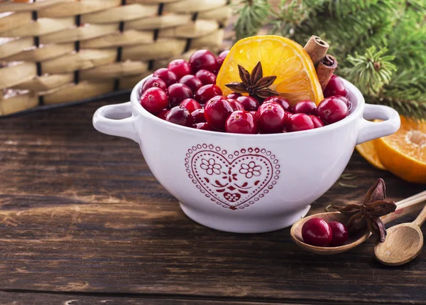 Cranberries with orange, cinnamon and star anise in a white ceramic — Stock Photo, Image