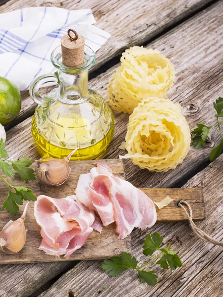 Ingredients for cooking fusilli pasta with bacon vegetables — ストック写真