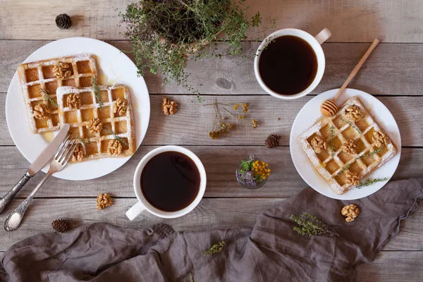 Waffles with honey, nuts, coffee and herbs, sweet dessert breakfast. — Stock Photo, Image