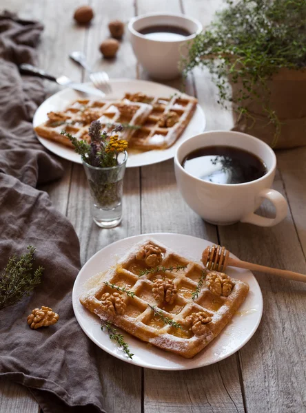 Belgian waffles breakfast with nuts, honey, herbs and coffee. — Stock Photo, Image