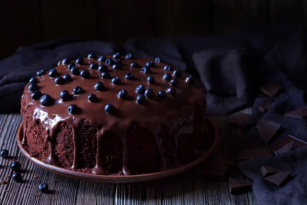 Chocolate cake decorated with blackberries on vintage wooden table background — Stock Photo, Image