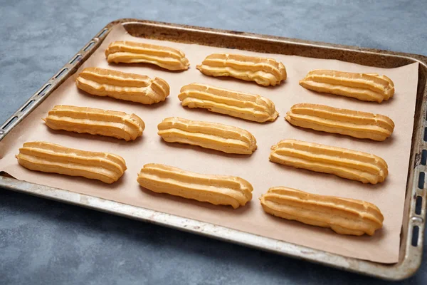 Traditional eclairs or profiterole dessert filled with whipped cream — Stock Photo, Image