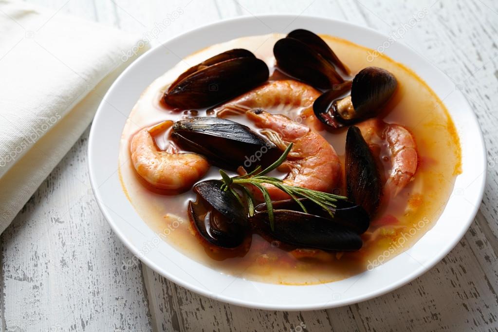 Fish seafood soup bouillabaisse. Mussels, shrimp, lobster in tomato