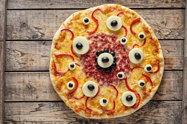 Halloween spaventoso cibo mostro pizza con gli occhi sul tavolo di legno vintage — Foto Stock