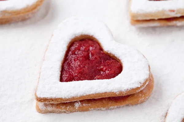 Heart shaped cookie with jam on white background — Stock Photo, Image