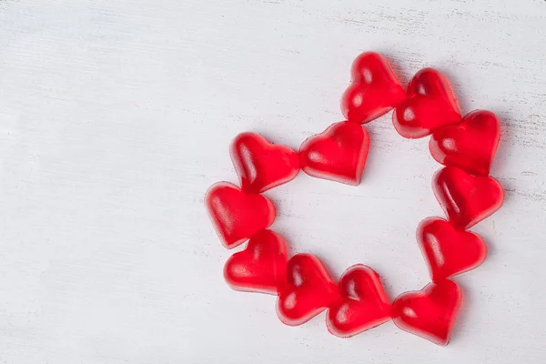 Heart shaped red jelly candies in heart form on vintage backgrou — Stock Photo, Image