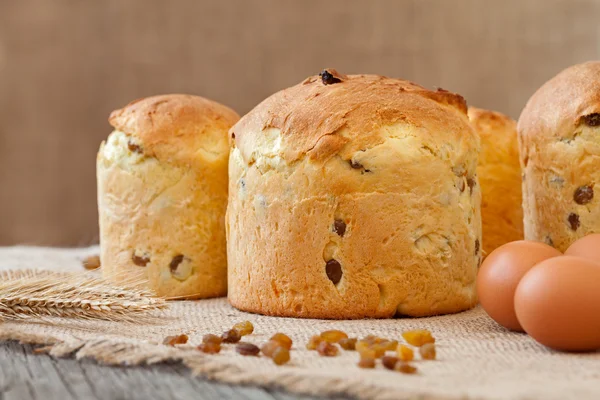 Traditional italian panettone holiday biscuit cake with raisins on vintage textile — Stock Photo, Image