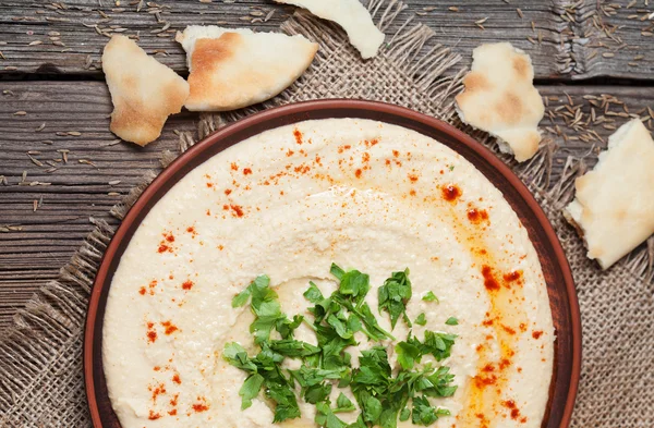 Plate of hummus, traditional lebanese food with pita, paprika and parsley — Stock Photo, Image