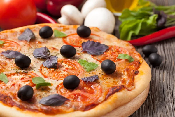 Italská pizza margherita s rajčaty, olivami a bazalkou na vint — Stock fotografie