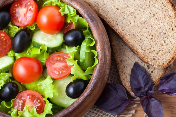 Spring super food vegetarian salad with tomato and olives on rus — Stock Photo, Image