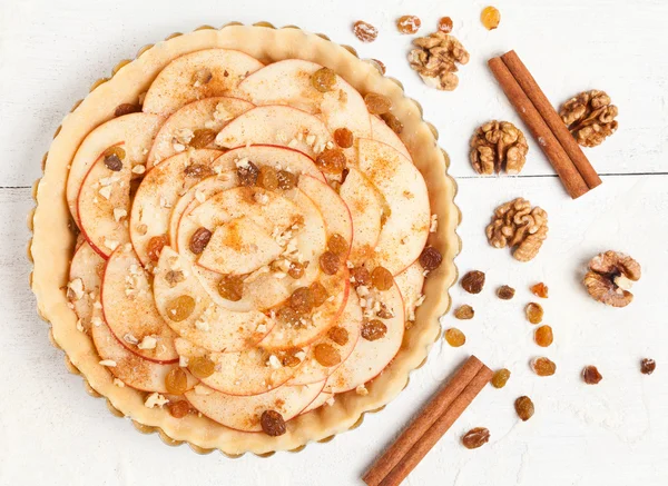 Preparación casera de pastel crudo de manzana. Tarta con manzanas, pasas, nueces y canela — Foto de Stock