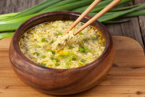 Receta tradicional de reinicio de sopa de gota de huevo étnico con palitos de comida que contienen trozos de huevos — Foto de Stock