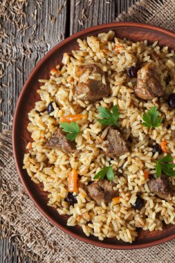 Arabic cuisine national rice food called pilaf with fried lamb meat, onion, carrot and garlic spice clipart